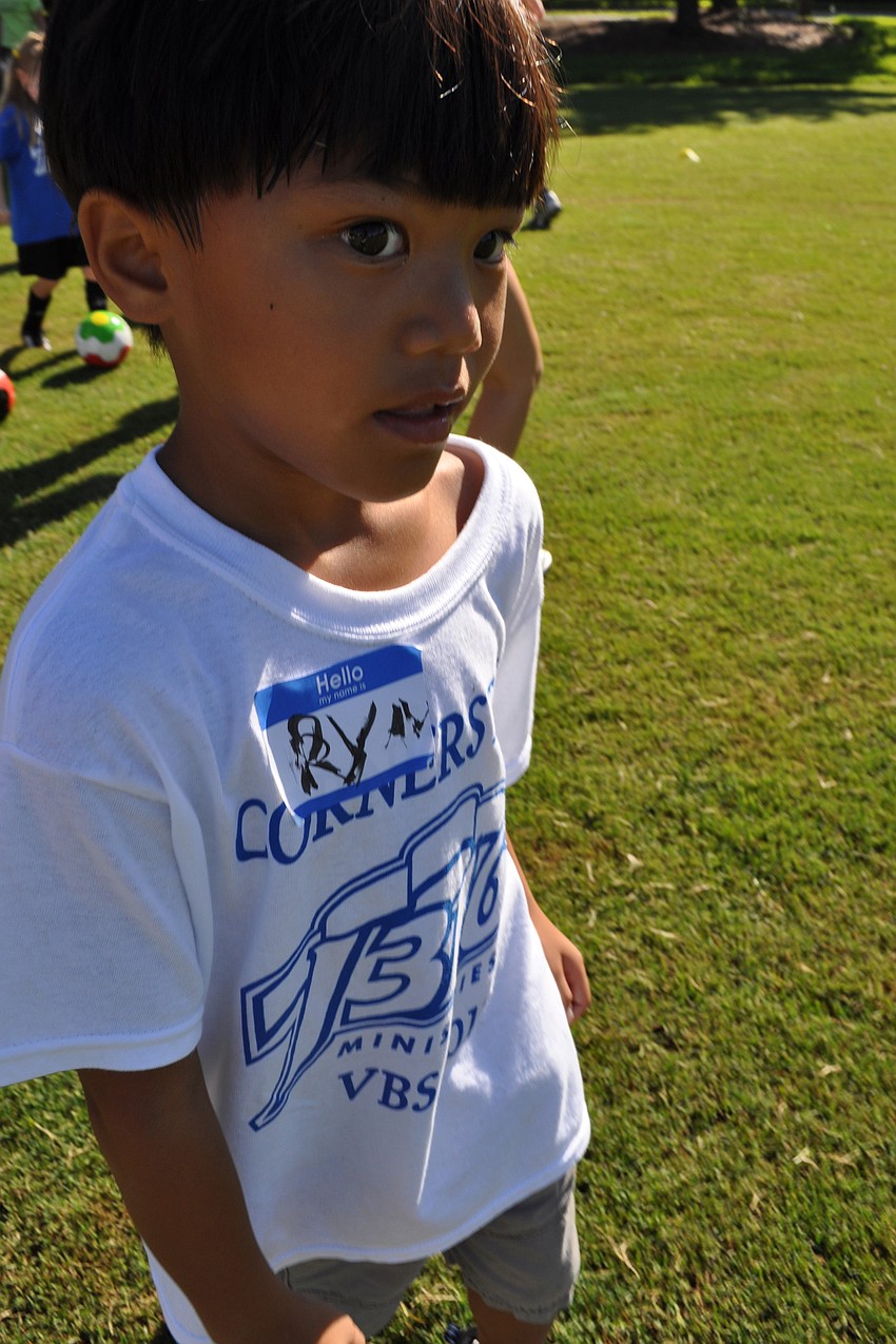 Ryan Shumway, 6, heads back to the shade, after a short practice drill.