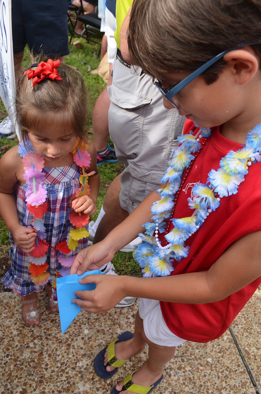 Dominic Torres, 6, helps his sister Isabella, 3, release butterflies the Longboat Key Garden Club provided.