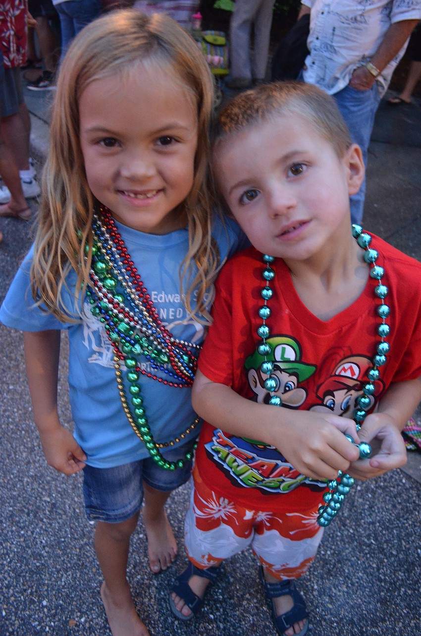 Kara Crawford, 7, and her brother Kameron, 6, dance at the block party after the parade.