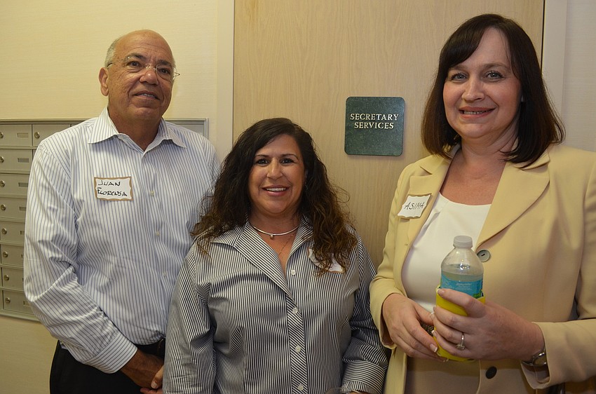 Longboat Key Public Works Director Juan Florensa , Yvonne Schloss of Sunglass Express Optical and Asima Palmer of SunTrust Bank
