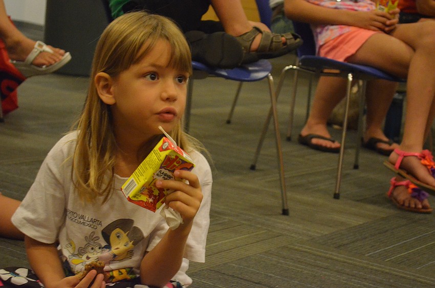 Audrey Olmstead, 5, listens to the Sarasota K-9 Search & Rescue presentation.