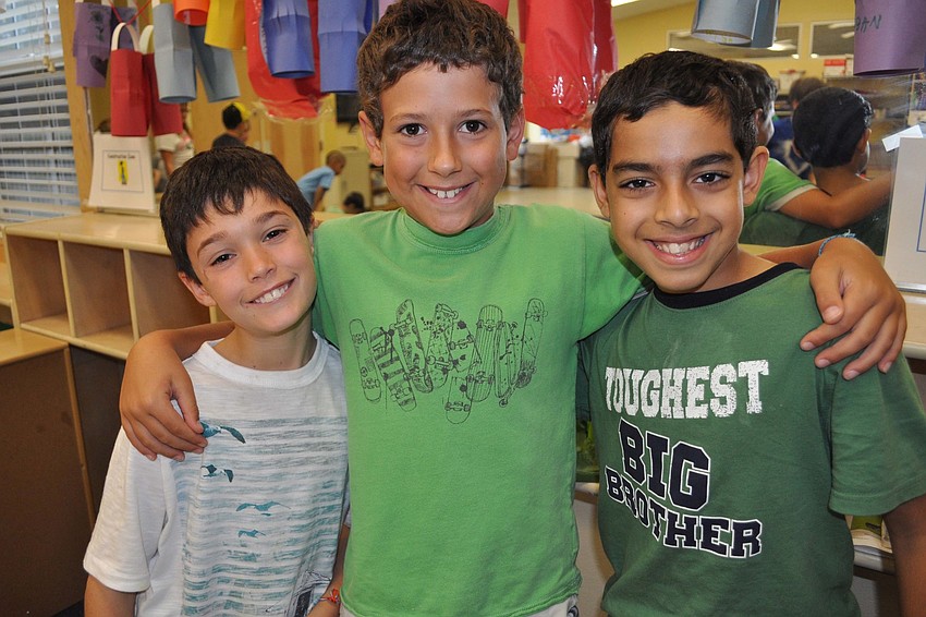 Cayden Kozma, Sulli Henry and Suvan Sethi enjoy the weekâ€™s activities together.