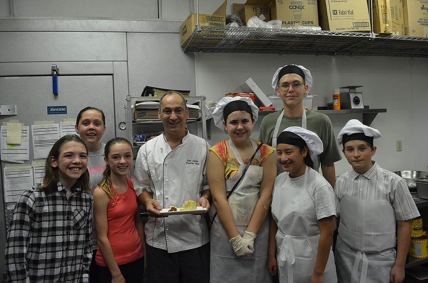 Pastry Chef Ray LaJolie holds a half-way-eaten sample platter of the Italian Ricotta Cheesecake and Torta di Nonna. Campers had to try a bite before bringing out the dessert to their guests.
