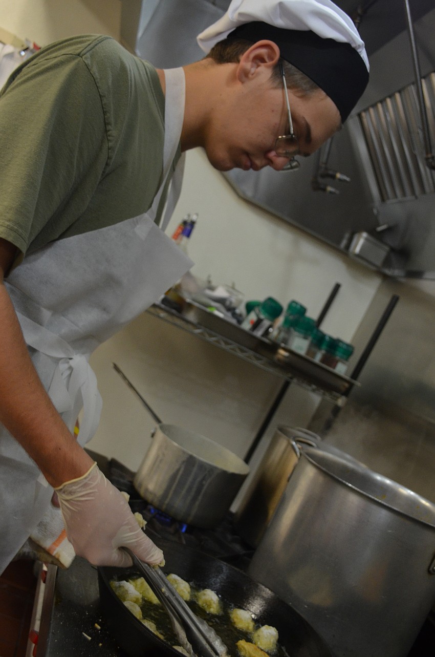 Max Aston, 15, fries up some artichokes for the appetizer, artichokes esther-style.