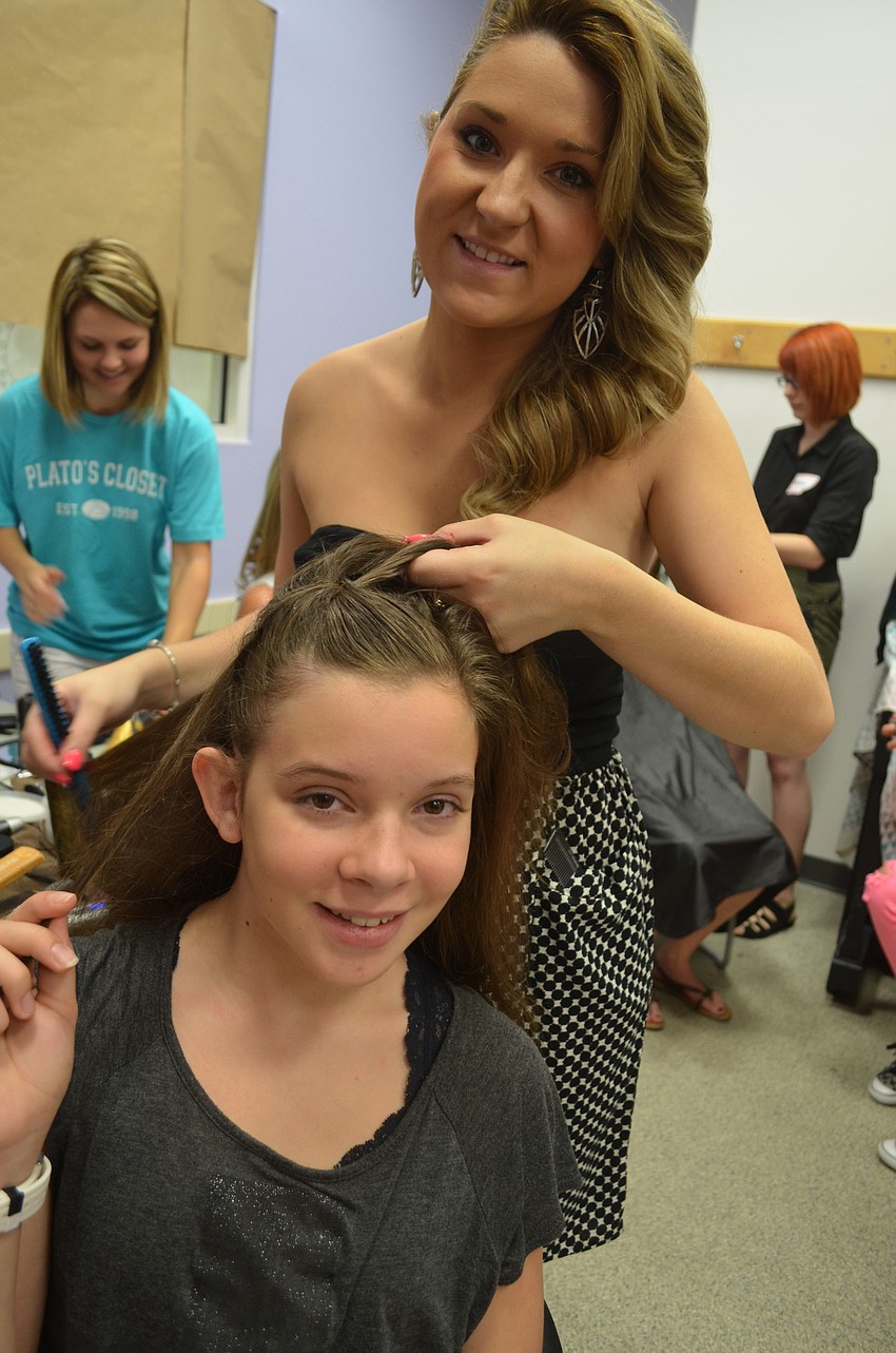 Kasey Gaskill, of Cutting Loose Hair Salon, does model Alyssa Hartzellâ€™s hair.