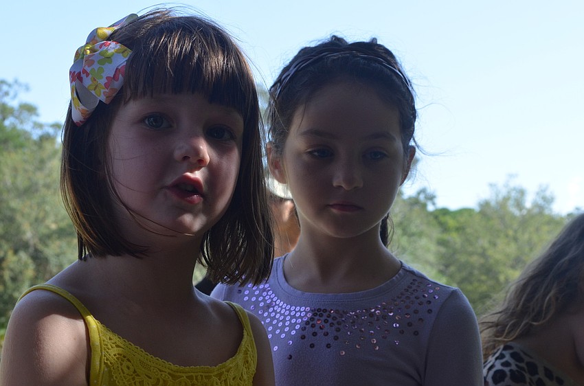 Claire Toale, 5, and Hannah Hardin, 7, listen and ask Land Stewart of the Conservation Foundation of the Gulf Coast Lee Amos questions on their nature tour.