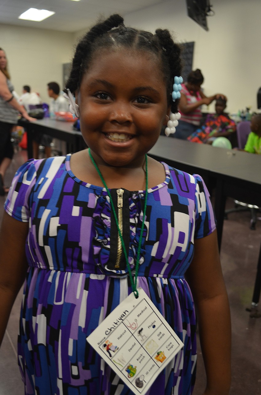 Chitiyah Bowman, 8, attends Emma E. Booker Elementary. She gets her hair done during the Fifth Annual Day of Hope.