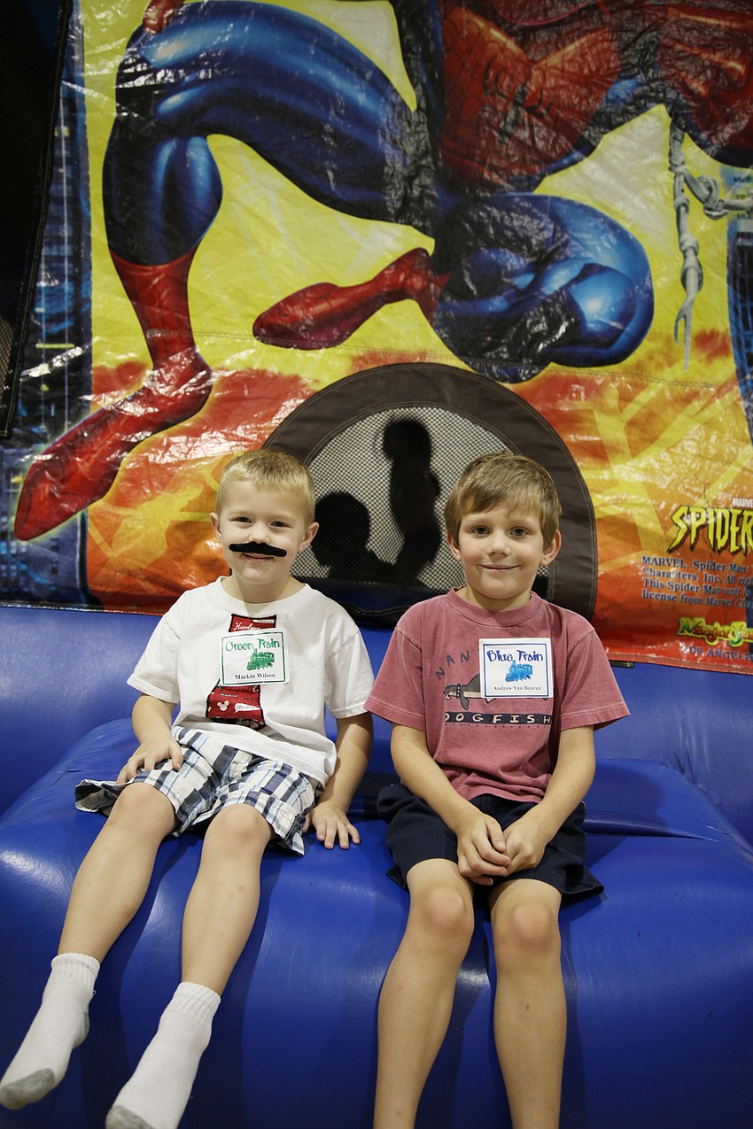 Mackin Wilson and Andrew Van Beuren pause from jumping in the Spider-Man bounce house to say hello.