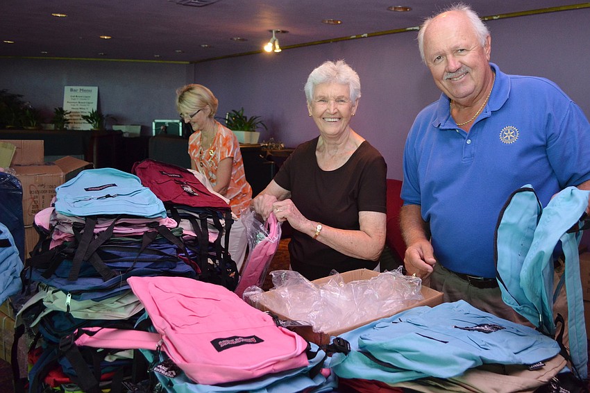 Gretel Mahaffey and Zoltan Karpathy unpack the backpacks for the event.
