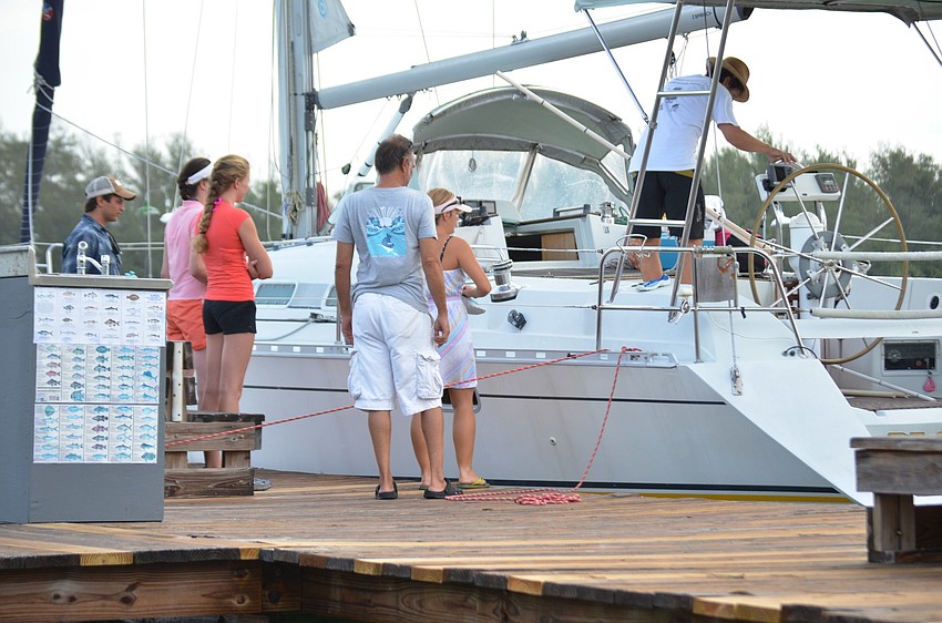 Sarasota Bay Watch volunteers board their boats to begin scallop searching in the bay.