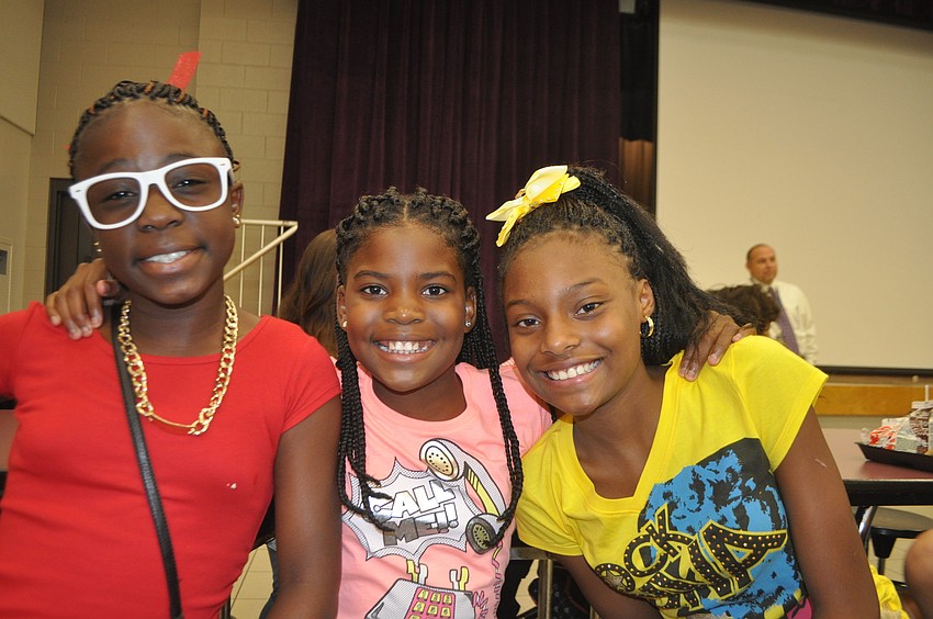 Jakiyah Jackson, 11, Cashanti Bradley, 11, and Kiara Bryant, 12, enjoy their first lunch as sixth graders.
