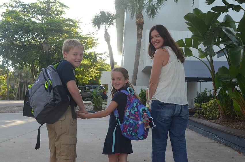 Beth LaGasse drops off her children Evan, 10, and Lexi, 7, at school for their first day.