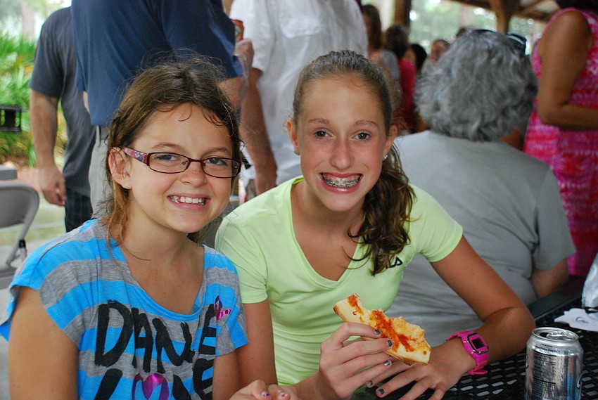 Julia Beatt and Abby Lipton enjoy some pizza.