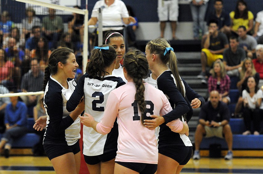 The Out-of-Door Academy volleyball celebrates a point during its 3-1 victory over Sarasota Christian School.