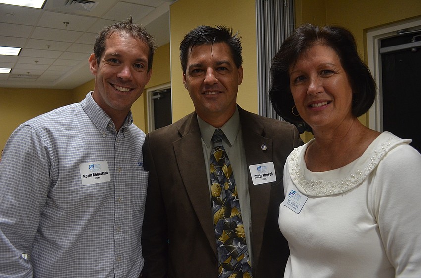 Norm Robertson of and Chris Showek of Atkins and Rae Dowling of the Manatee Chamber of Commerce