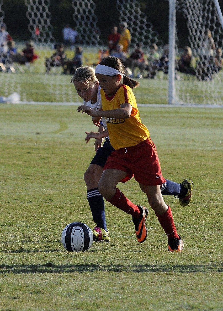 Ten-year-old Chloey Conte pushes the ball up the field for the Clearwater Chargers U11 team.