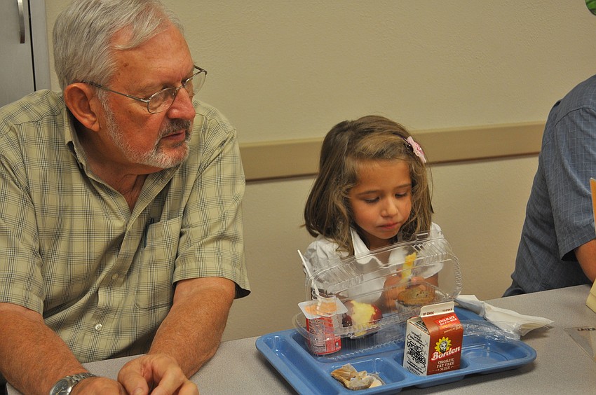 Charles Rose sits with his granddaughter, Shannon Schroeder, in Braden River Elementary cafeteria