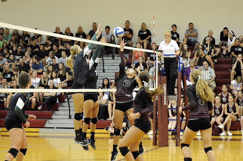 Braden River setter Courtney Rapp attempts to get the ball past Lakewood Ranchâ€™s Coleen Campbell and Lauren Owens.