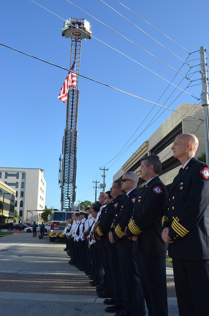 Assistant Fire Chief Rod VonOrsdol and other firefighters honor the fallen during the ceremony.