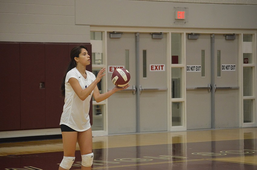 Booker player Yamaris Guevarez prepares to serve.
