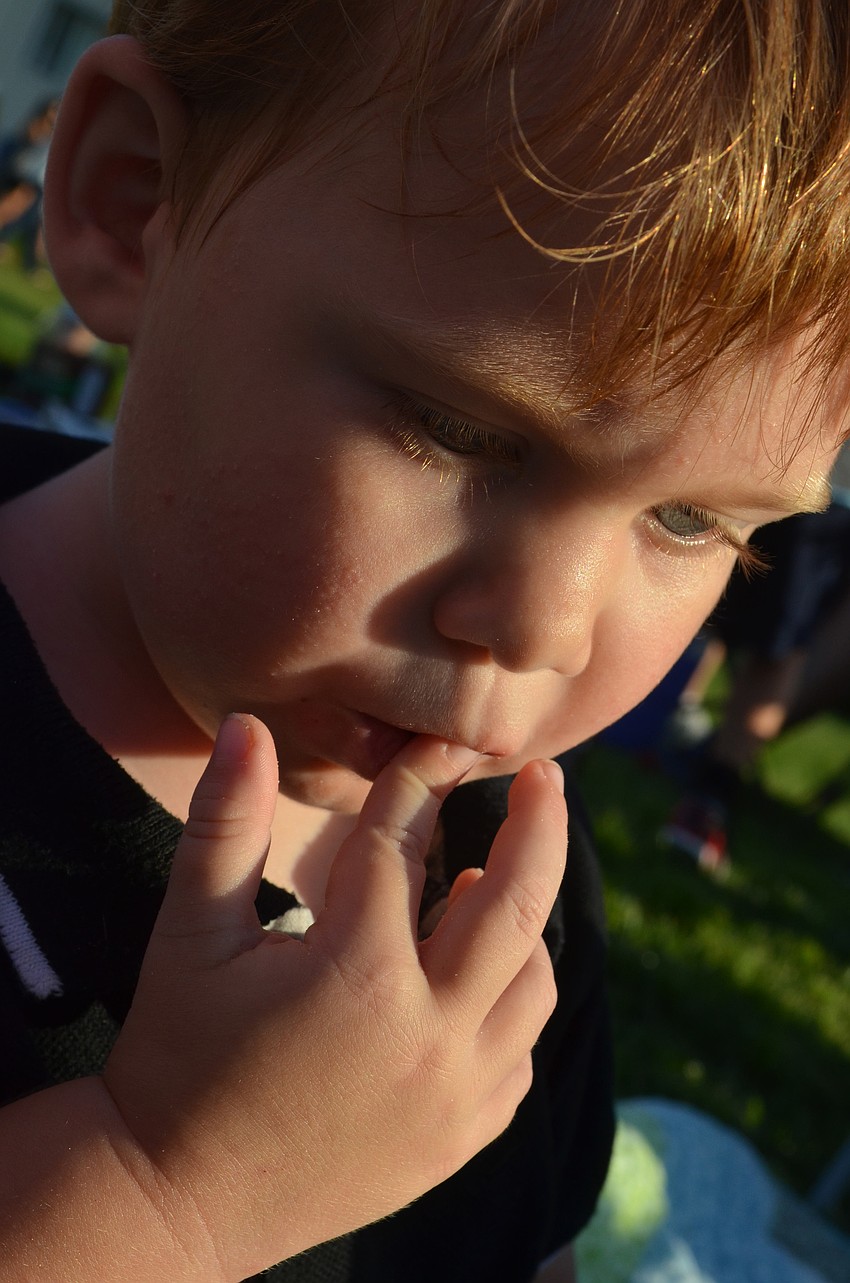 Asher Wyckoff, 2, munches on cheerios during the tailgate.