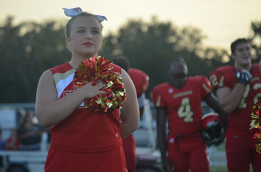 Elizabeth Reynolds, 16, watches the American flag during the National Anthem.