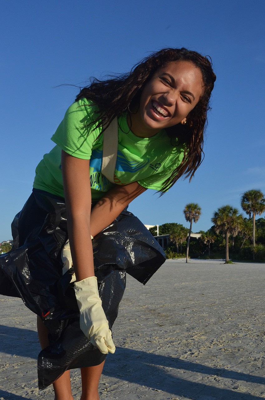 Arianny Bueno, 17, enjoys helping the environment and her community Saturday morning.