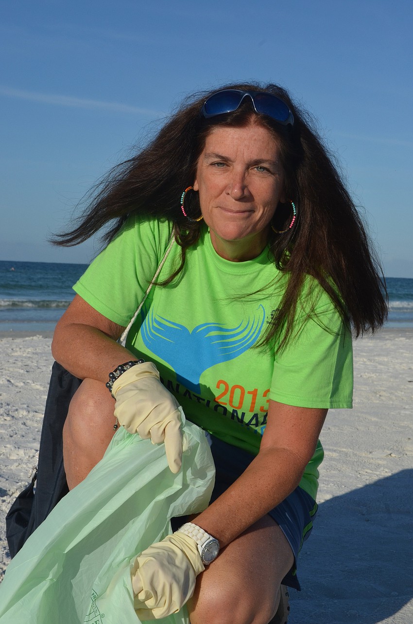 Maureen Greck picks up trash Saturday morning.