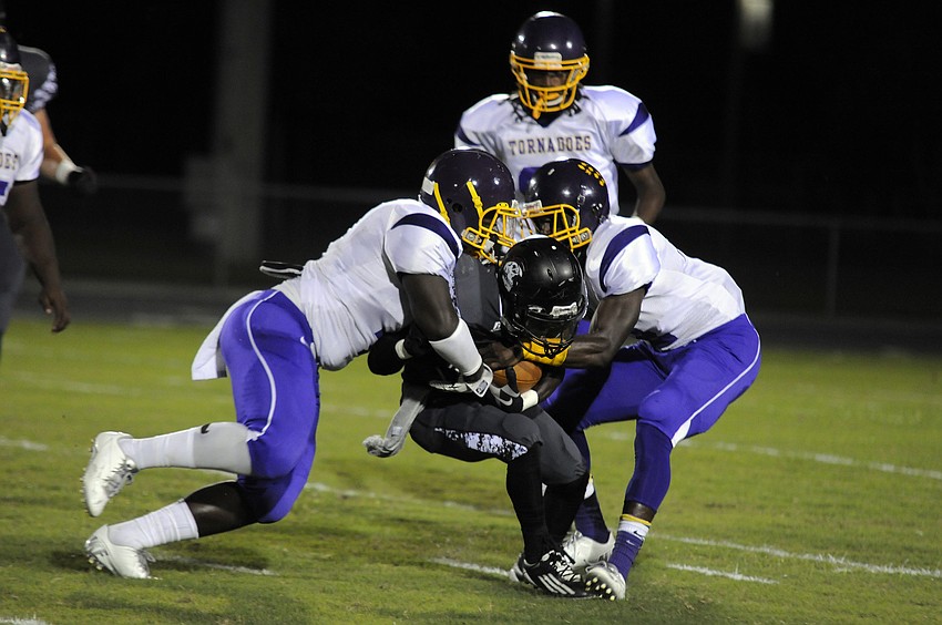A pair of Booker defenders tackle Braden River running back Titus Humphrey for a minimal gain.