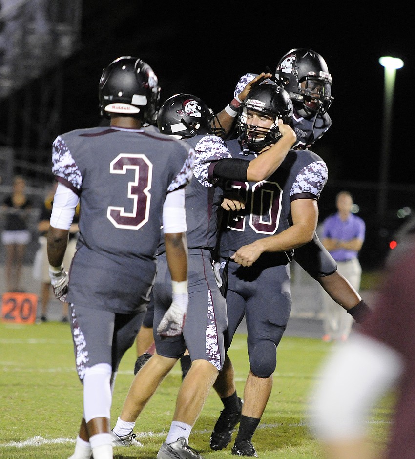 Braden River senior Marcus Balliette is congratulated by his teammates following his 8-yard touchdown catch with 1:04 left in regulation.
