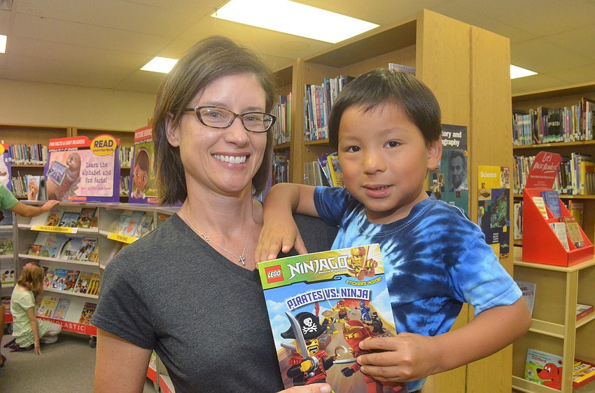 Amanda Georgiades and her son Shawn, 4, head to the check out counter to purchase a book.