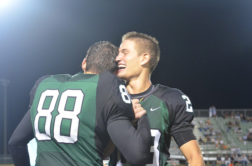 Senior Ty Mcleod congratulates his friend Wyatt Mcleod for winning King.