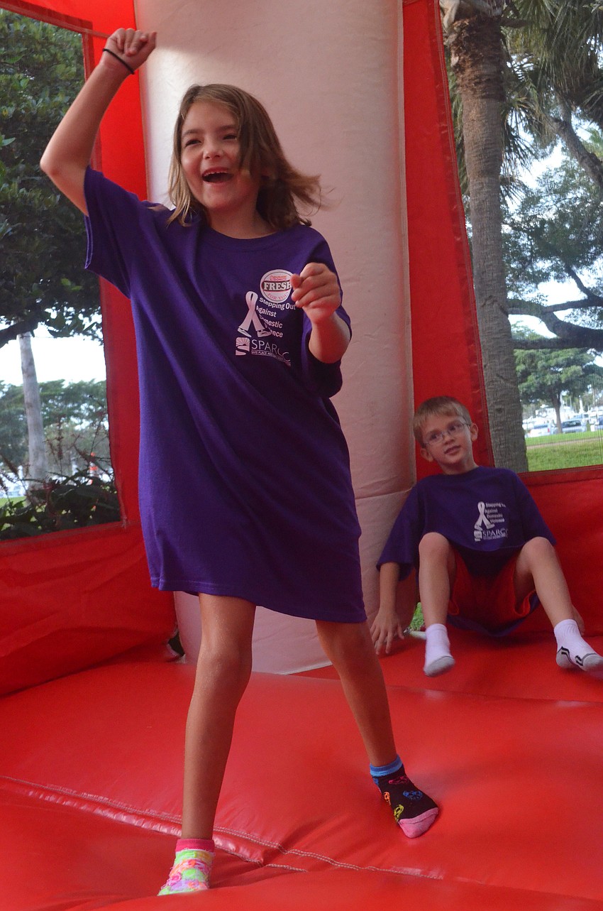 Kelsey Berroyer, 8, and her cousin James Perhealth, 7, play in the bounce house.