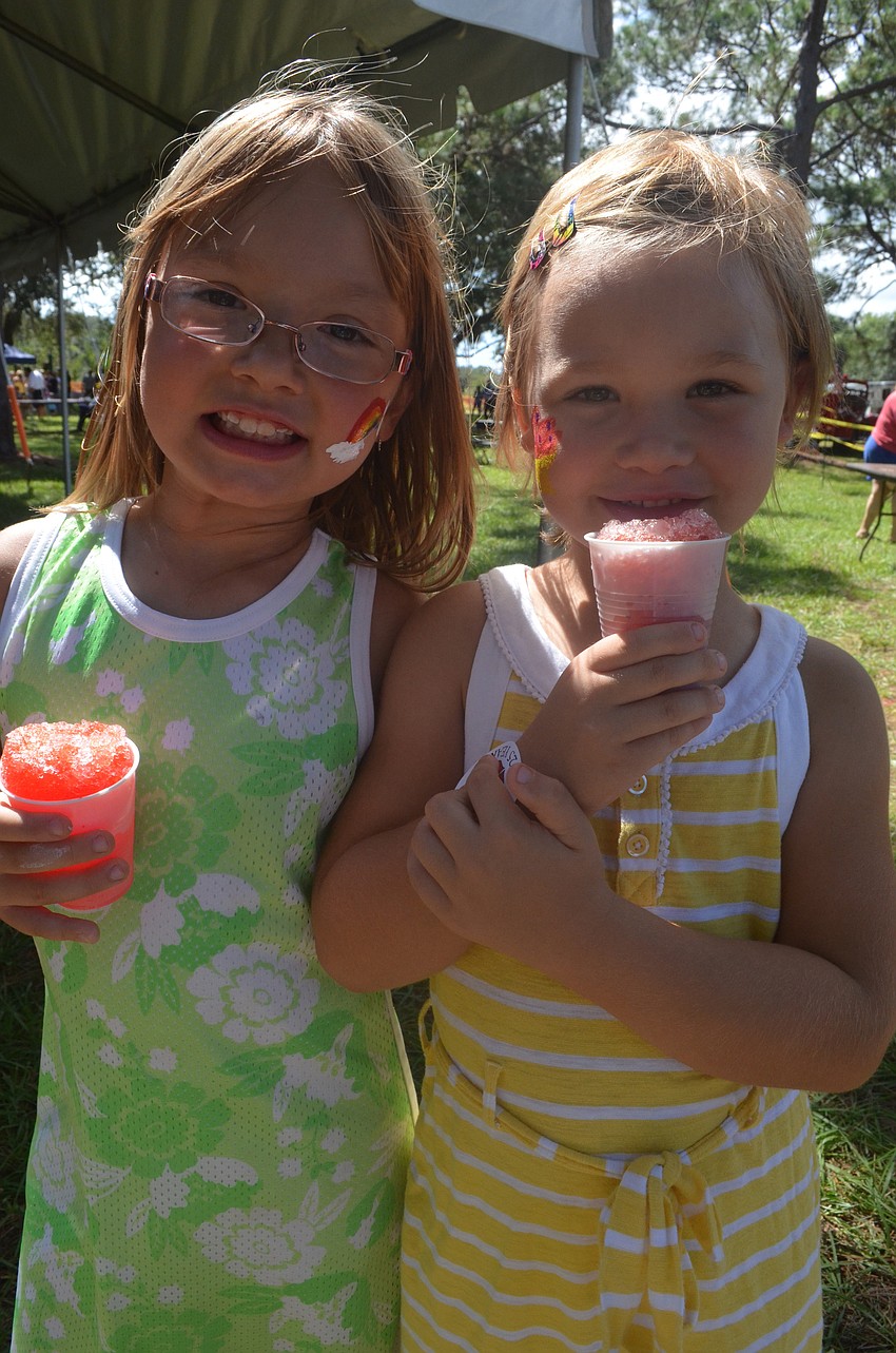 Gabby Gerdes, 7, and her sister Layla, 5, enjoy snow cone treats at the open house.