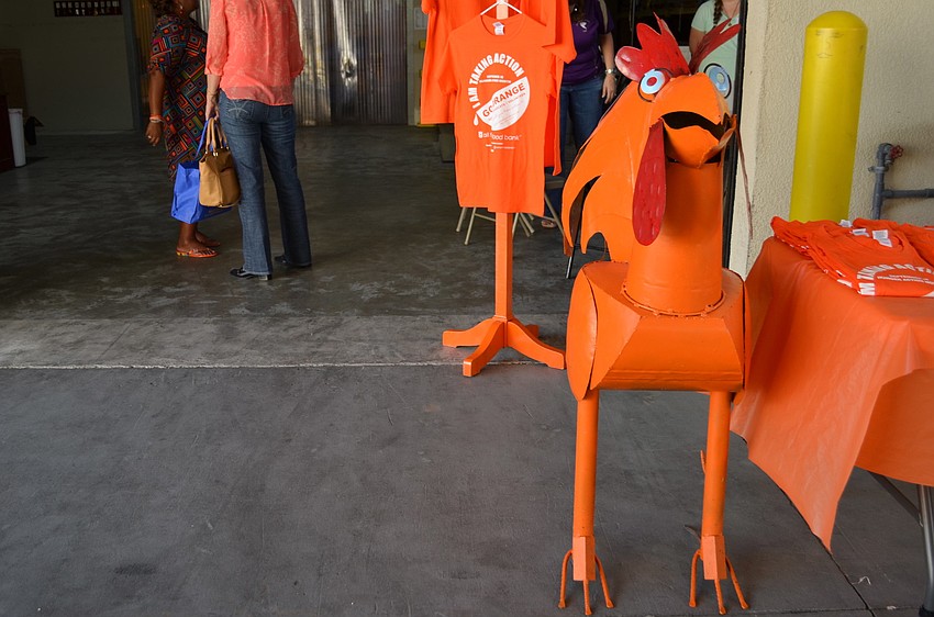 Sarasota Architectural Salvage provided All Faiths Food Bank with a rooster that they painted orange and displayed during Hunger Action Month.