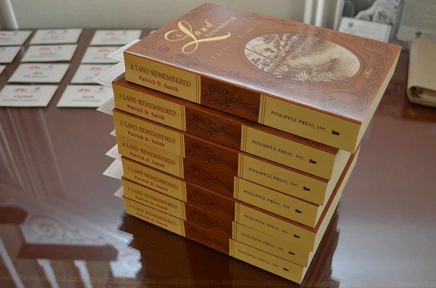 Each guest at the reception received a copy of â€˜A Land Remembered.â€™
