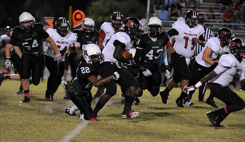 Lakewood Ranch defensive back Brandon Luckett wraps up Palmetto running back Joshua Hicks.