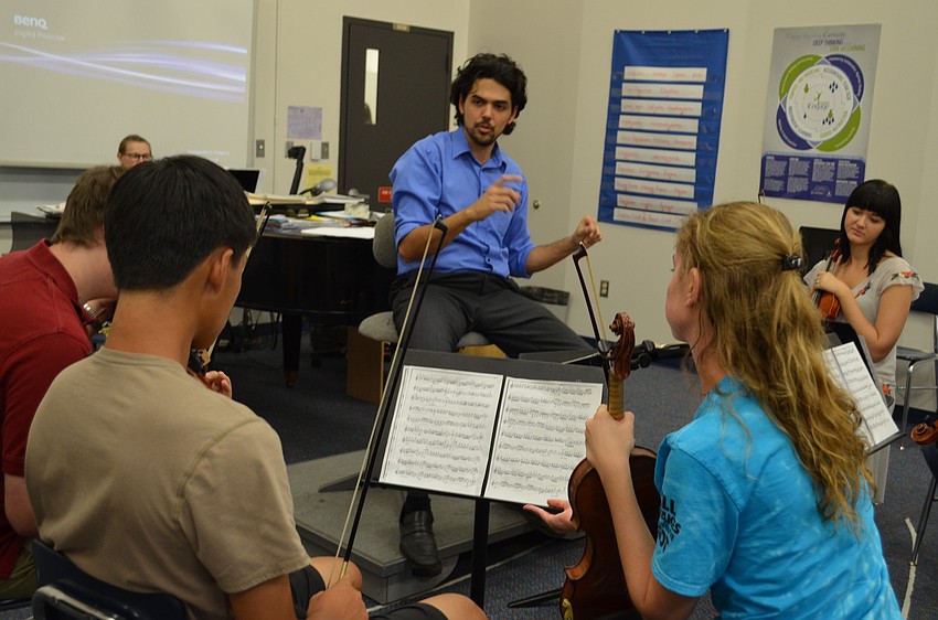 Victor Fernandez works with the 11th and 12th grade students on ensemble and tempo.
