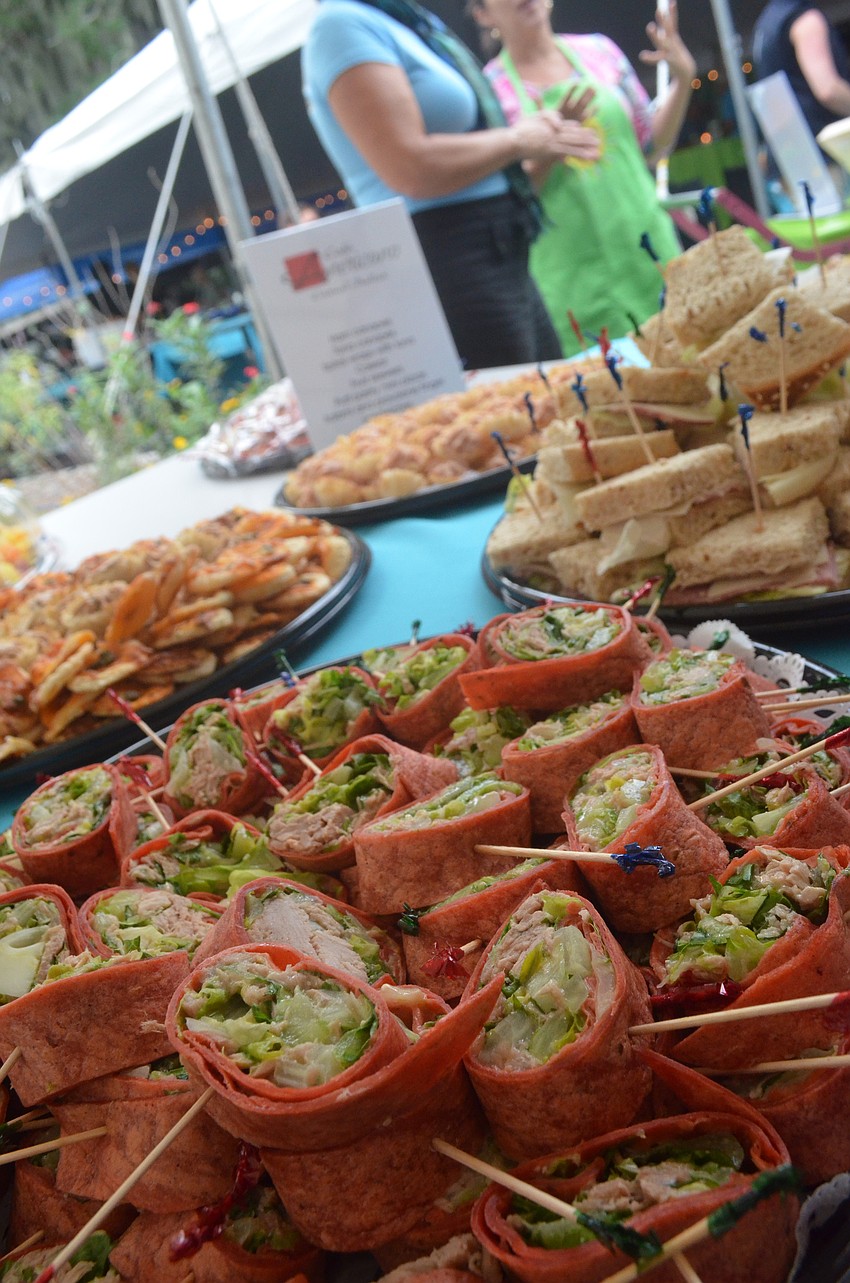 CafÃ© Americano served finger sandwiches and pinwheel tuna rolls.