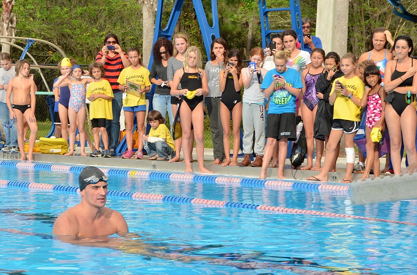 The crowd of Sarasota Sharks and their families wraps around each side of the lap pool.