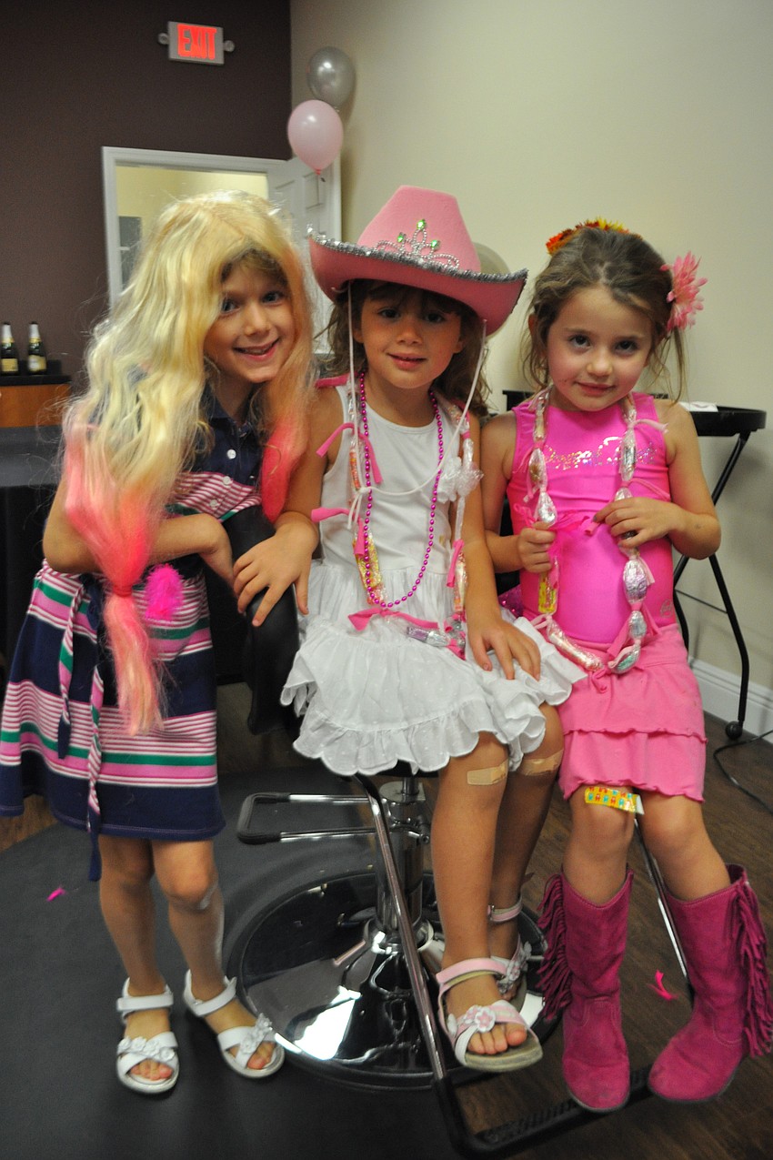 Sisters Giulia, 6, and Aurora Lorenzoni,4, enjoy dressing up with Isabella Juliano,5.