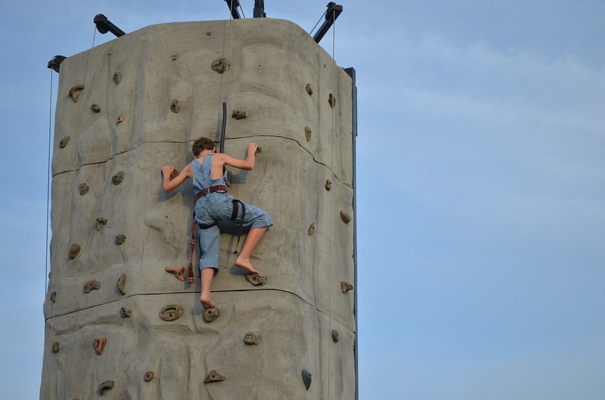 Ben Walmsley climbs the rock wall.