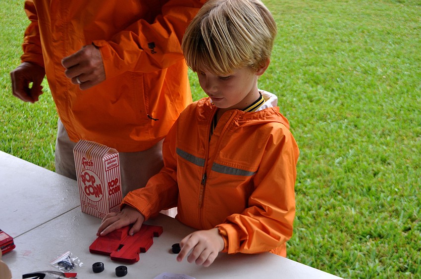 A father, Jeff, and son, Will, 7, team up to craft a wooden car.
