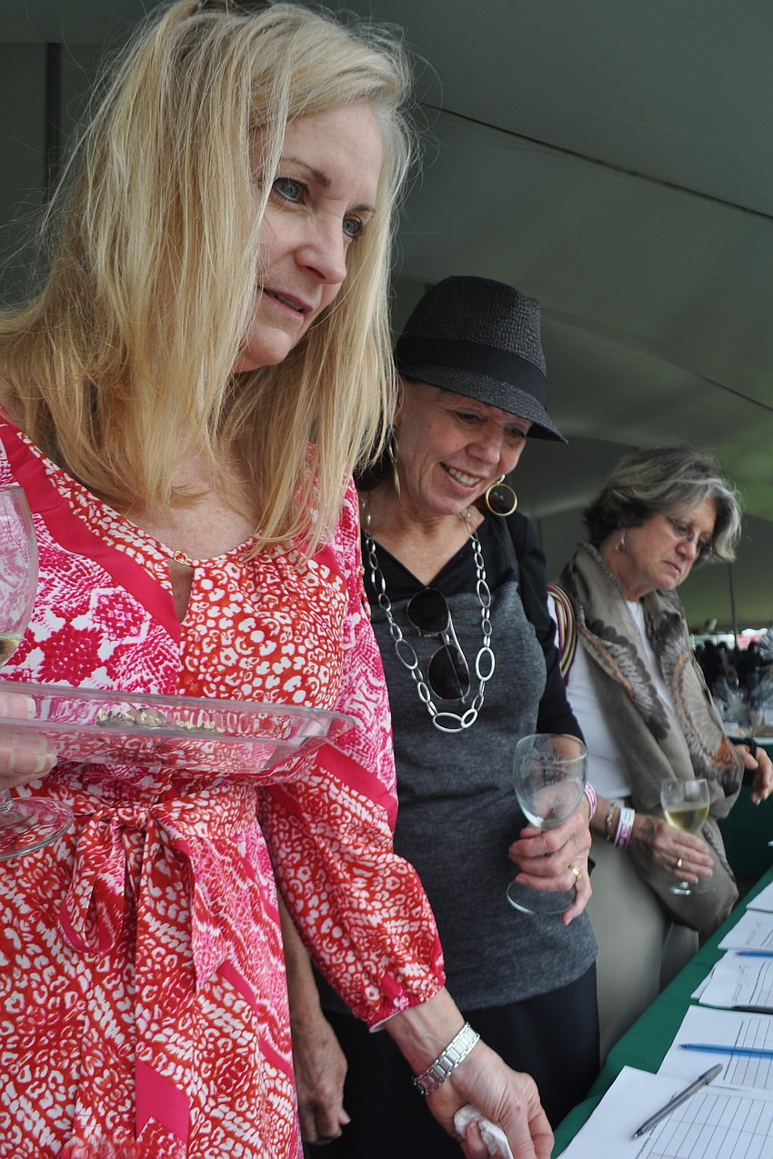 Sharyl Smith, front, looked through the silent auction items.