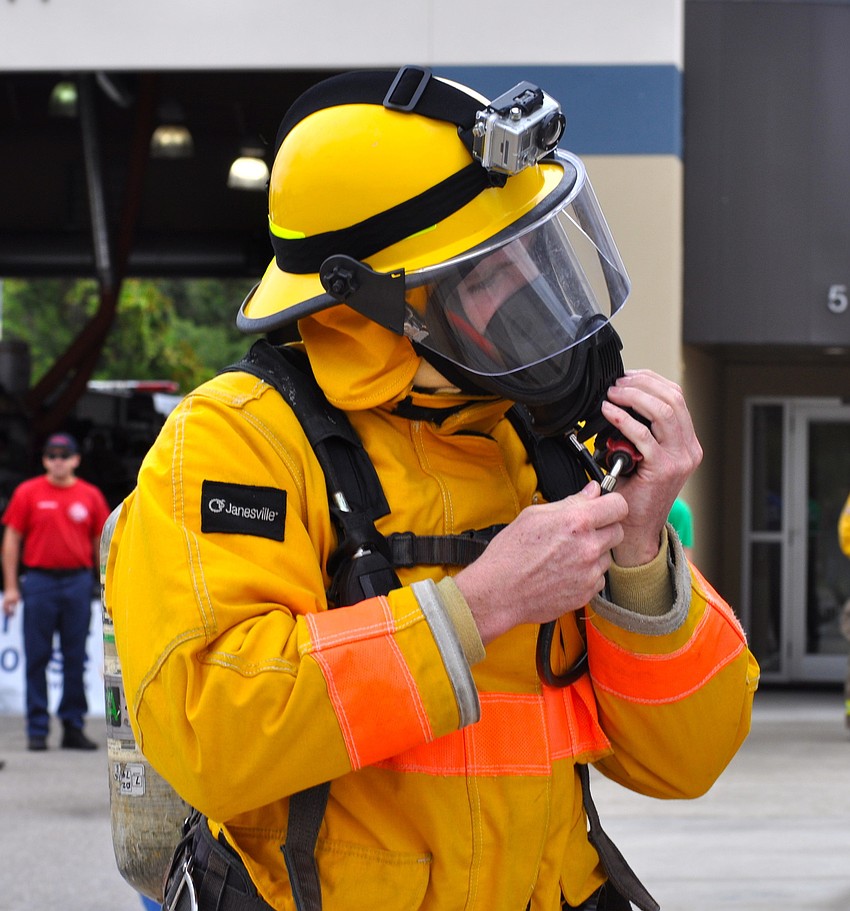 Beau Smith-Kerr gets his fire suit ready before racing up six flights of stairs.