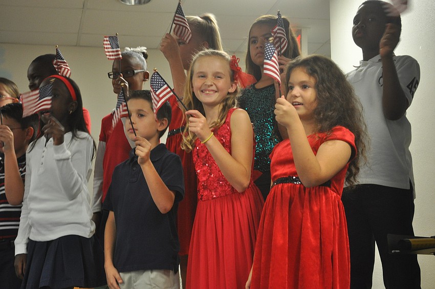 The students waved American flags in pride.