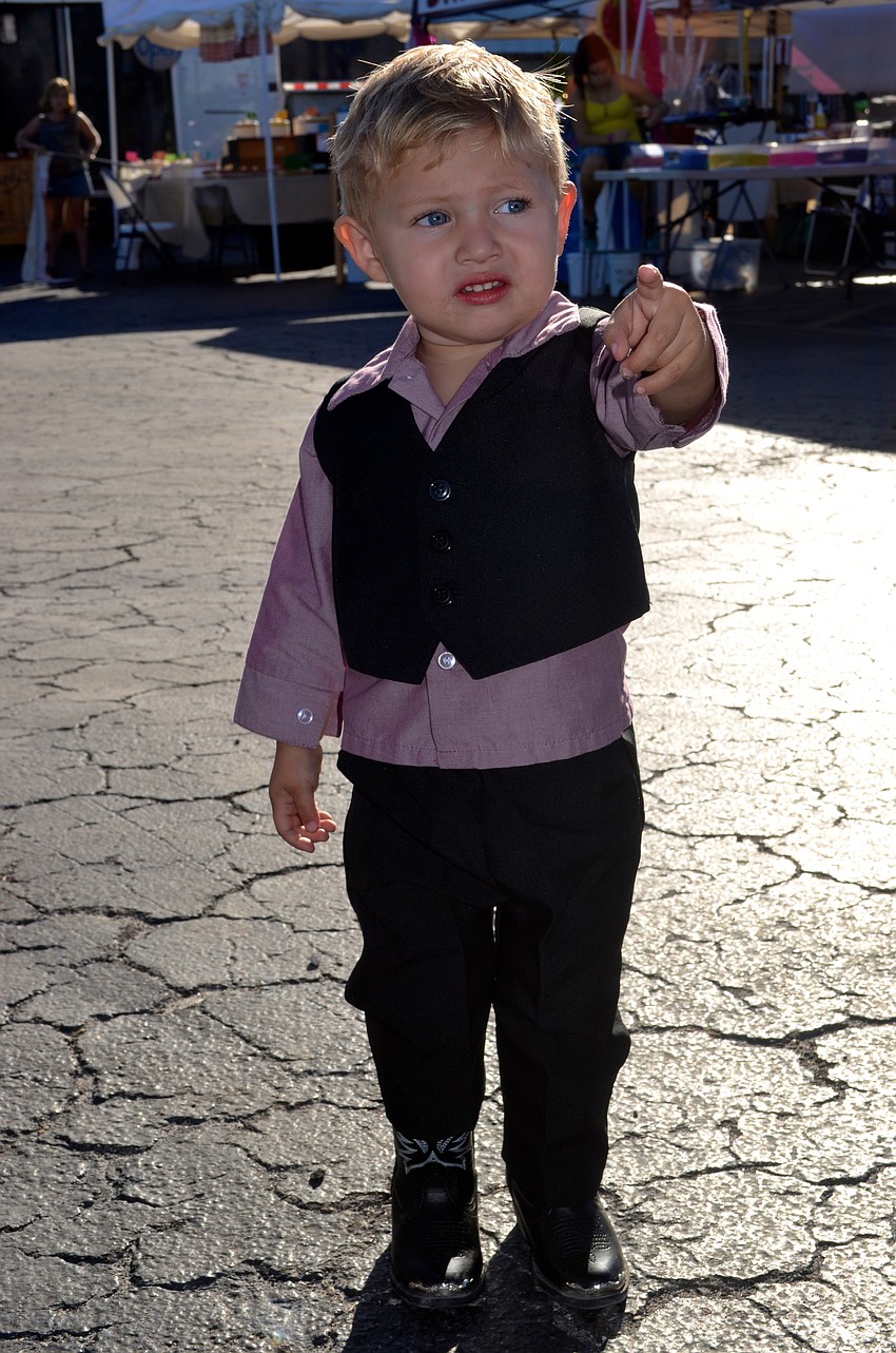 Aidin Harper, 2, leads the way with his grandmother following closely behind.