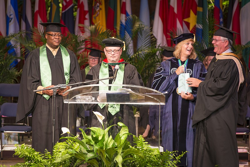 SCF President Dr. Carol F. Probstfeld and her husband, William A. Murphy, receive gifts for their two â€œfur children,â€ Harpo, a smooth-coated red Brussels Griffon, and Nixie, a Portuguese water dog.