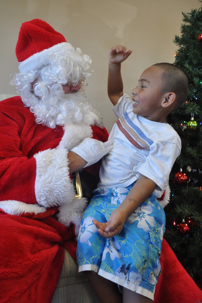 Avery Gonzalez, 3, shares his Christmas wish list with Santa.