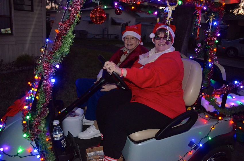 Donna Amsden and her niece Maxine Teachout enjoy the view of the other brightly-lit carts.